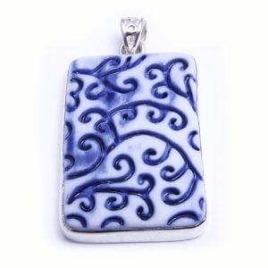 Fern is a hand carved rectangular pendant of glazed porcelain set in sterling silver. Available in four colours.