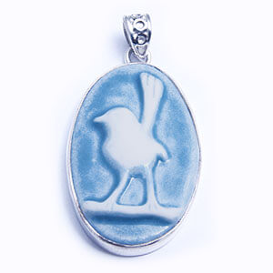 Wren, hand carved porcelain pendant set in sterling silver. Available in four colours.