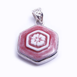 Hana is a hand carved hexagonal porcelain pendant glazed and set in sterling silver. Available in light blue, red, blue and grey.