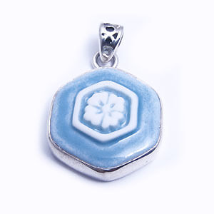 Hana is a hand carved hexagonal porcelain pendant glazed and set in sterling silver. Available in light blue, red, blue and grey.