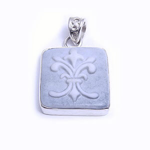Flordelis is a hand carved rectangular porcelain pendant glazed and set in sterling silver. Available in blue, light blue, red and grey.