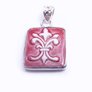 Flordelis is a hand carved rectangular porcelain pendant glazed and set in sterling silver. Available in blue, light blue, red and grey.