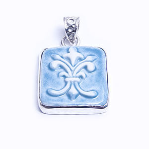Flordelis is a hand carved rectangular porcelain pendant glazed and set in sterling silver. Available in blue, light blue, red and grey.