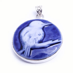 Kingfisher, a round handcarved porcelain pendant, set in sterling silver. Available in grey, blue, light blue and red.