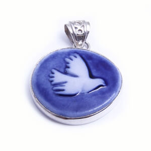 Dove - a hand carved porcelain pendant set in sterling silver. Available in red, grey, blue and light blue.