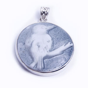Kingfisher, a round handcarved porcelain pendant, set in sterling silver. Available in grey, blue, light blue and red.