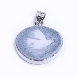 Dove - a hand carved porcelain pendant set in sterling silver. Available in red, grey, blue and light blue.