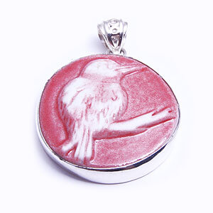 Kingfisher, a round handcarved porcelain pendant, set in sterling silver. Available in grey, blue, light blue and red.