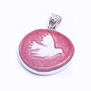 Dove - a hand carved porcelain pendant set in sterling silver. Available in red, grey, blue and light blue.