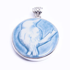 Kingfisher, a round handcarved porcelain pendant, set in sterling silver. Available in grey, blue, light blue and red.