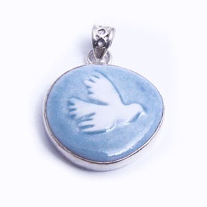 Dove - a hand carved porcelain pendant set in sterling silver. Available in red, grey, blue and light blue.