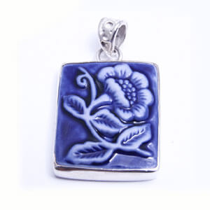 Beauty - a hand carved porcelain pendant set in sterling silver. Available in red, blue, grey and light blue.