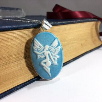 turquoise fairy porcelain cameo set in silver with a book background