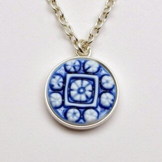 blue porcelain and silver cameo charm in a silver necklace