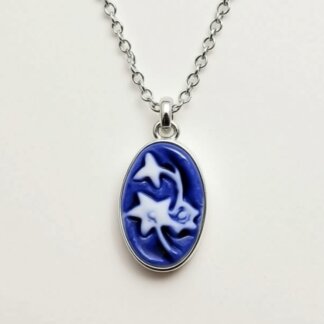 blue porcelain and silver cameo charm in a silver necklace