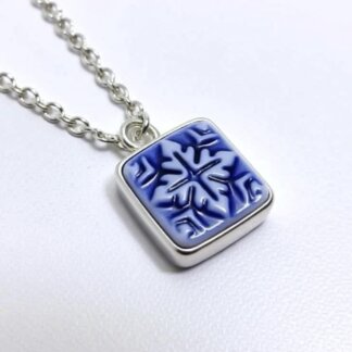 mosaic porcelain and silver cameo charm in a silver necklace