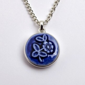 blue porcelain and silver cameo charm in a silver necklace