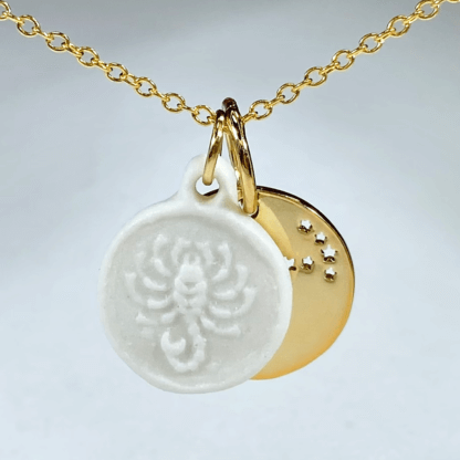 Scorpio white porcelain coin medallion with gold chain and brass constellation disc