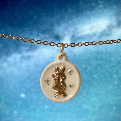 Gemini white and gold porcelain coin medallion with gold chain