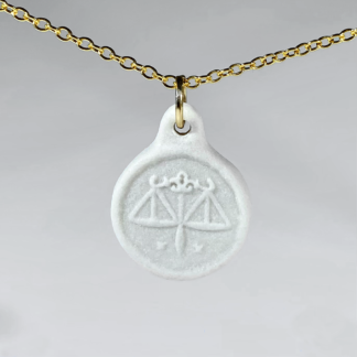Libra white coin medallion with gold chain