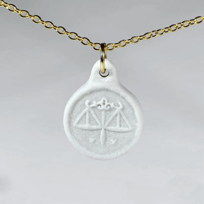 Libra white coin medallion with gold chain