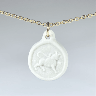 Taurus white porcelain coin medallion with gold chain
