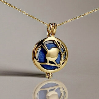 brass bird locket with a blue stone inside