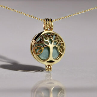 brass tree locket with a green stone inside